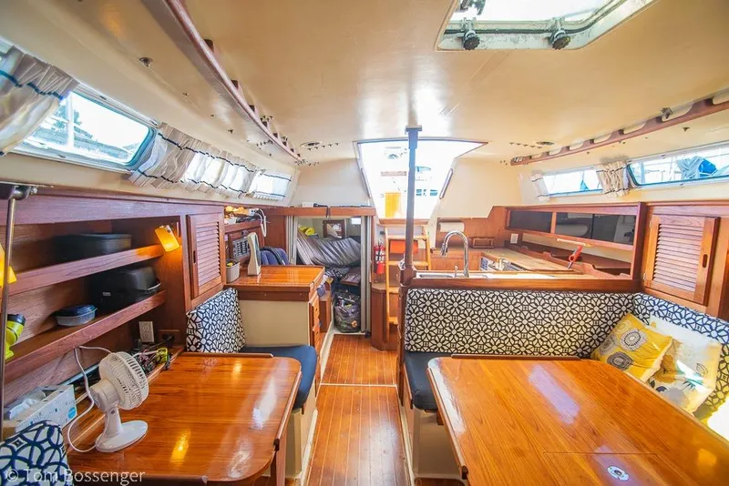 Slide: The Image of Interior of a 1985 Catalina 36 sailboat with wooden furnishings and cozy seating. - 22