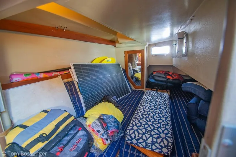 Slide: The Image of Interior of 1985 Catalina 36 sailboat with storage items and patterned cushions. - 23
