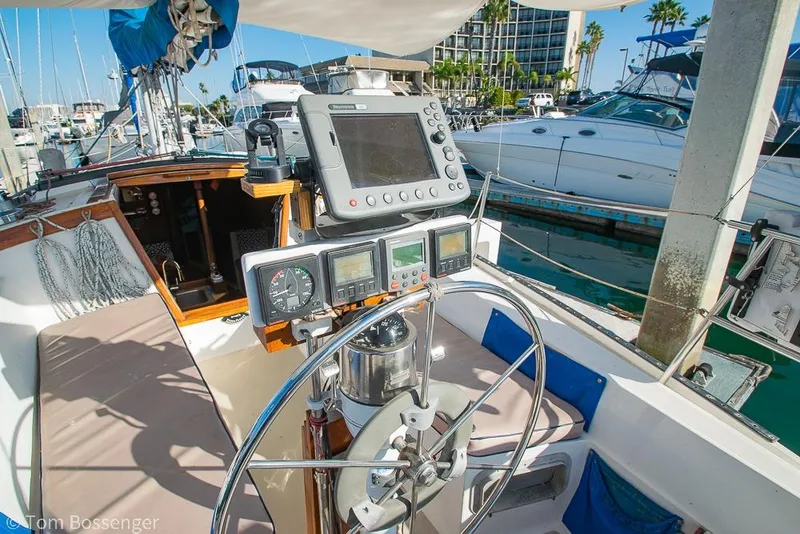 Slide: The Image of Cockpit of a 1985 Catalina 36 sailboat with navigation equipment and marina view. - 27