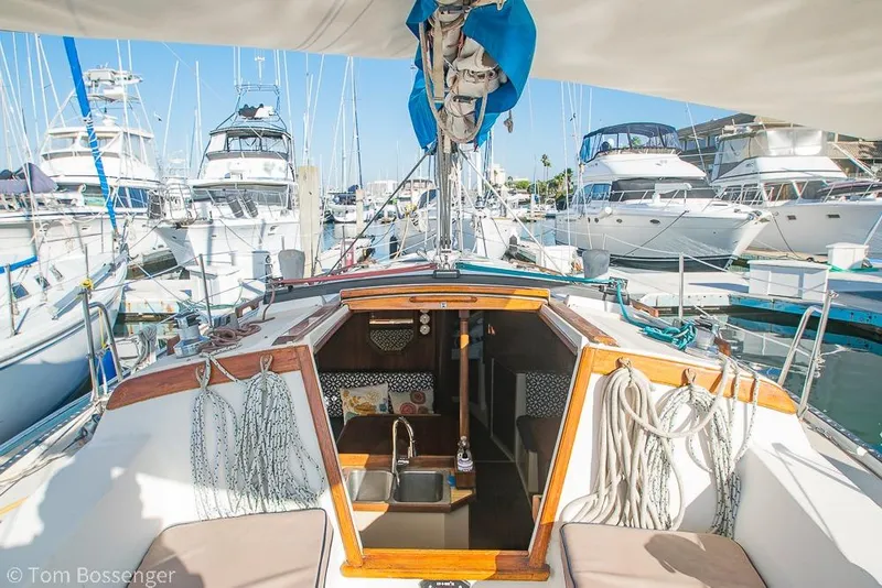 Slide: The Image of 1985 Catalina 36 sailboat docked in marina, interior view with sink and ropes. - 32