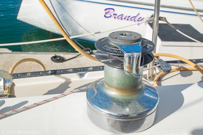 Slide: The Image of Winch on 1985 Catalina 36 sailboat deck, with ropes and boat name visible. - 33