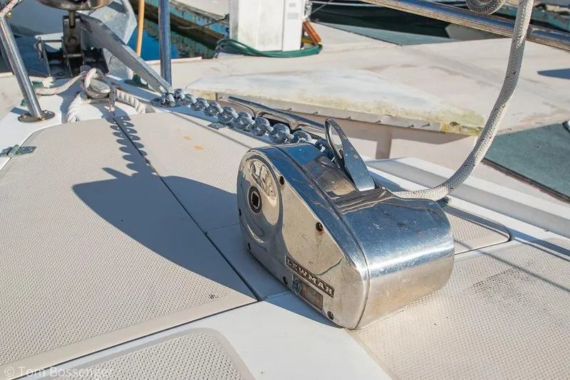Slide: The Image of Anchor windlass on 1985 Catalina 36 sailboat deck, with chain and rope. - 38