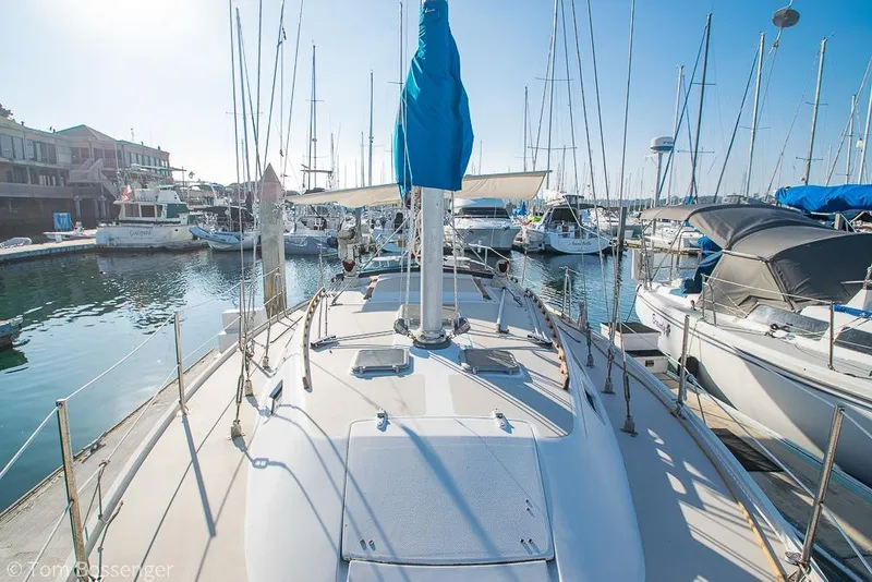 Slide: The Image of 1985 Catalina 36 sailboat docked in a marina, surrounded by other boats. - 41