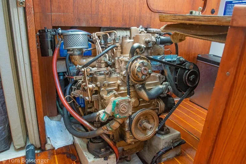 Slide: The Image of Engine of a 1985 Catalina 36 sailboat, showcasing mechanical components and wooden interior. - 44