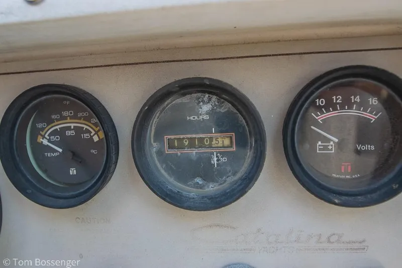 Slide: The Image of Dashboard gauges of a 1985 Catalina 36 yacht, showing temperature, hours, and voltage. - 45