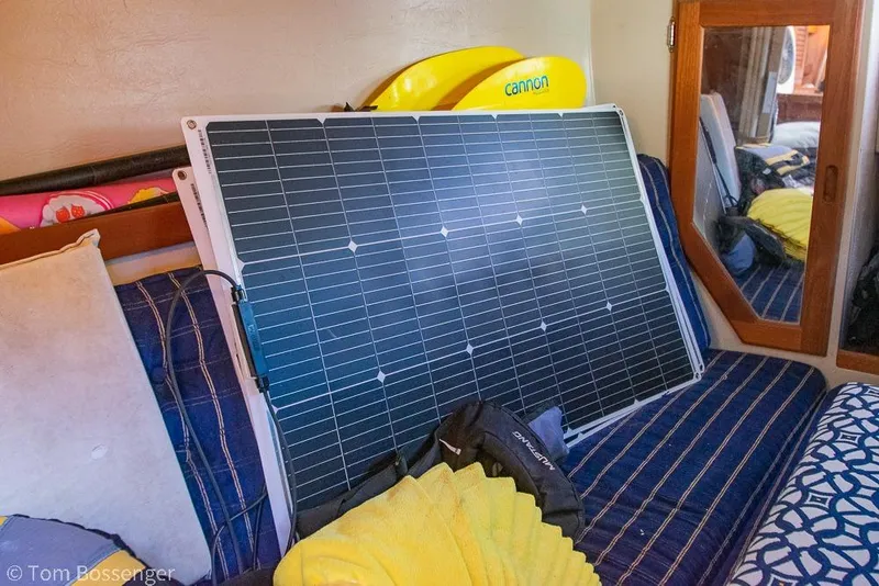 Slide: The Image of Solar panel inside 1985 Catalina 36 yacht cabin with striped cushions and mirror. - 46