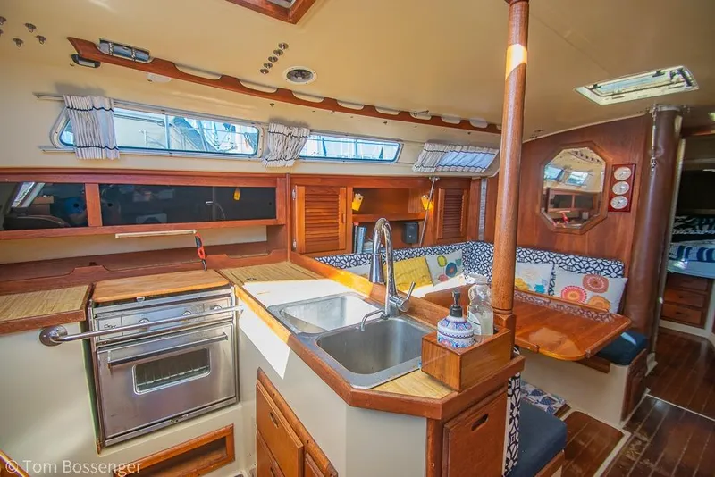 Slide: The Image of Interior of 1985 Catalina 36 sailboat with kitchen and seating area. - 6