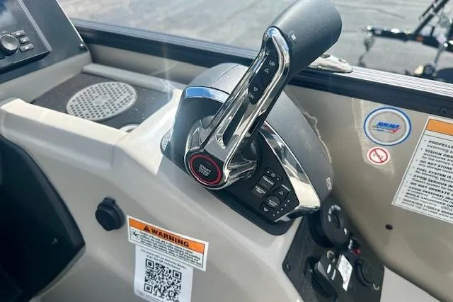 Slide: The Image of Control panel of 2026 Barletta C22M boat with throttle lever and warning labels. - 15