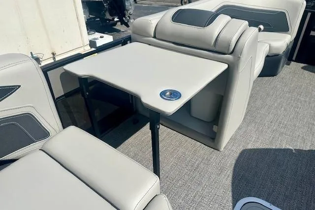 Slide: The Image of 2026 Barletta C22M boat interior with beige seating and a foldable table. - 19
