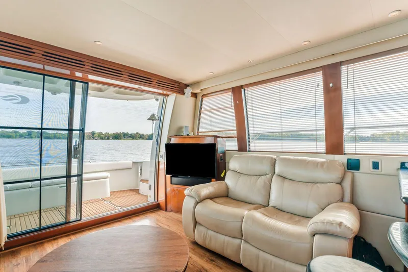 Slide: The Image of Luxurious interior of 2004 Carver 570 Voyager Pilothouse yacht with leather seating and scenic views. - 13
