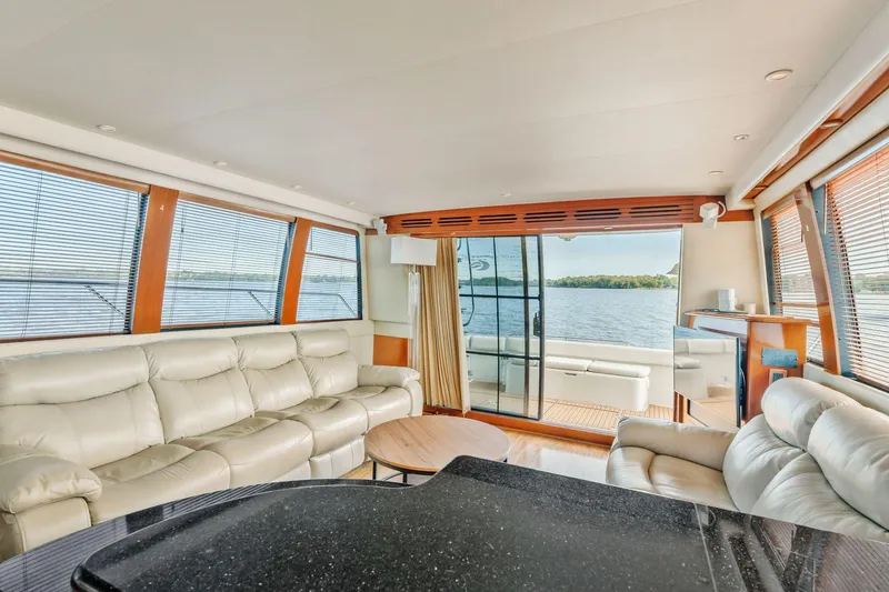 Slide: The Image of Luxurious interior of 2004 Carver 570 Voyager Pilothouse yacht with leather seating and panoramic windows. - 16