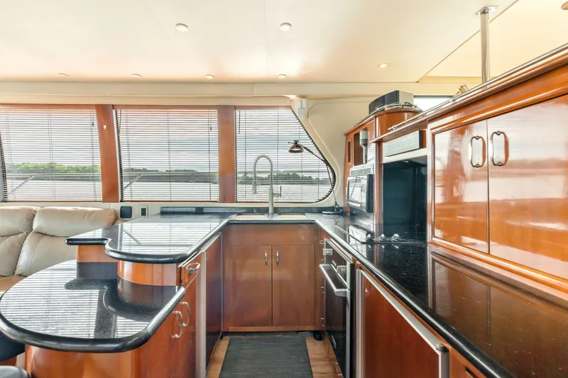 Slide: The Image of Luxurious kitchen interior of 2004 Carver 570 Voyager Pilothouse yacht with wood cabinetry. - 17