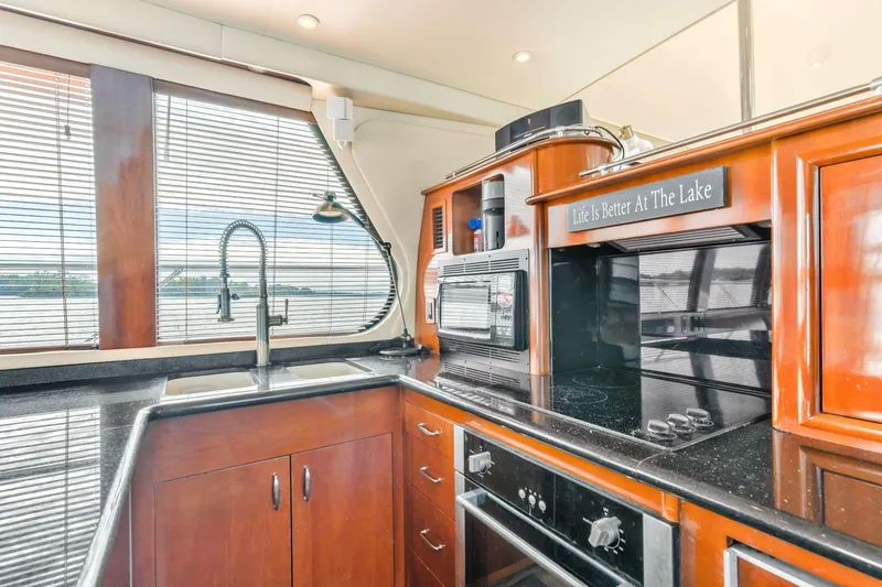 Slide: The Image of Luxurious kitchen interior of 2004 Carver 570 Voyager Pilothouse yacht with modern appliances. - 18