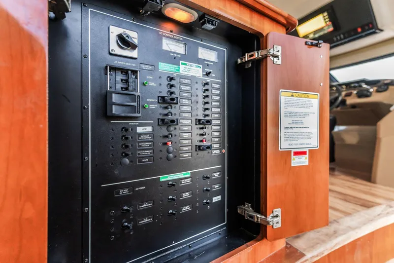 Slide: The Image of Electrical control panel inside 2004 Carver 570 Voyager Pilothouse yacht, featuring switches and indicators. - 22