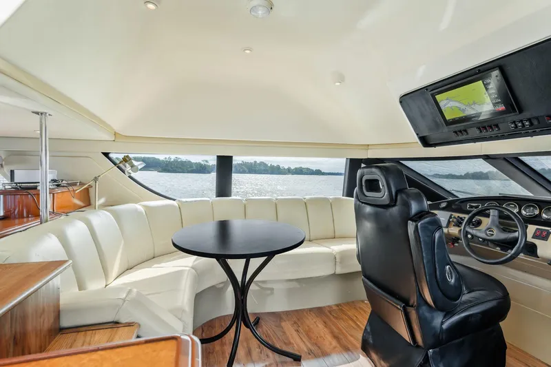 Slide: The Image of Luxurious interior of 2004 Carver 570 Voyager Pilothouse with leather seating and navigation controls. - 25