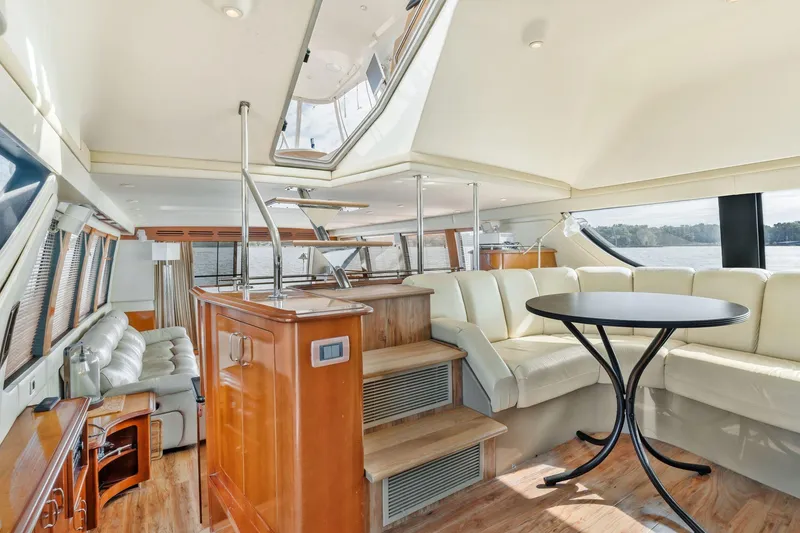Slide: The Image of Luxurious interior of 2004 Carver 570 Voyager Pilothouse with elegant seating and wooden finishes. - 26