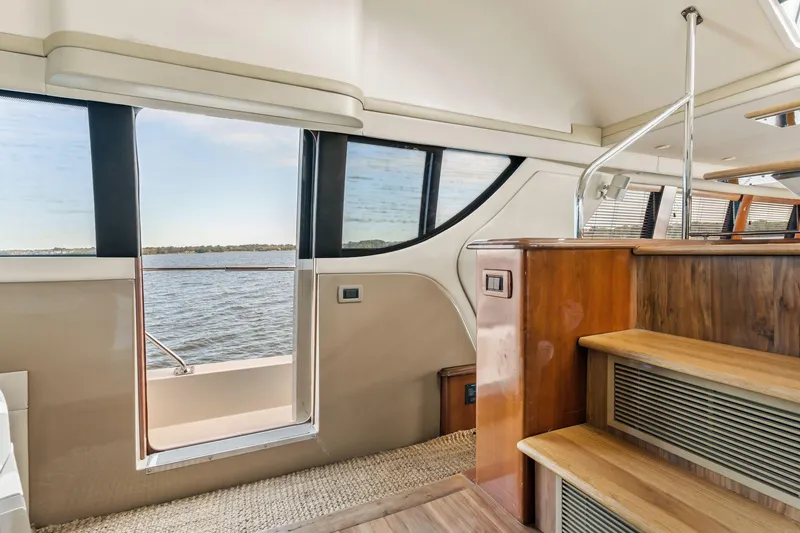 Slide: The Image of Interior view of 2004 Carver 570 Voyager Pilothouse with wooden stairs and water view. - 27