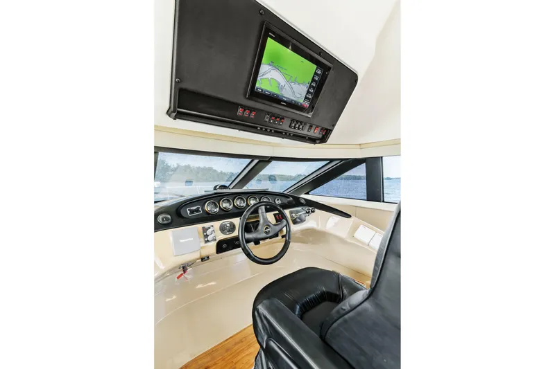 Slide: The Image of Pilothouse interior of 2004 Carver 570 Voyager, featuring navigation equipment and steering wheel. - 28