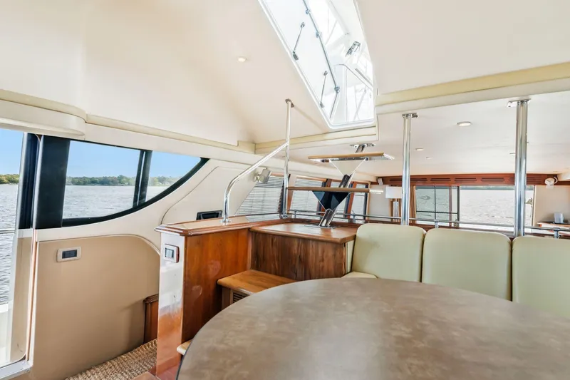 Slide: The Image of Luxurious interior of 2004 Carver 570 Voyager Pilothouse yacht with elegant seating and panoramic windows. - 29
