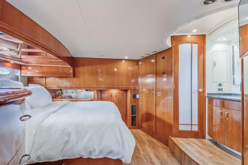 Slide: The Image of Luxurious 2004 Carver 570 Voyager Pilothouse bedroom with elegant wood finishes and modern amenities. - 31