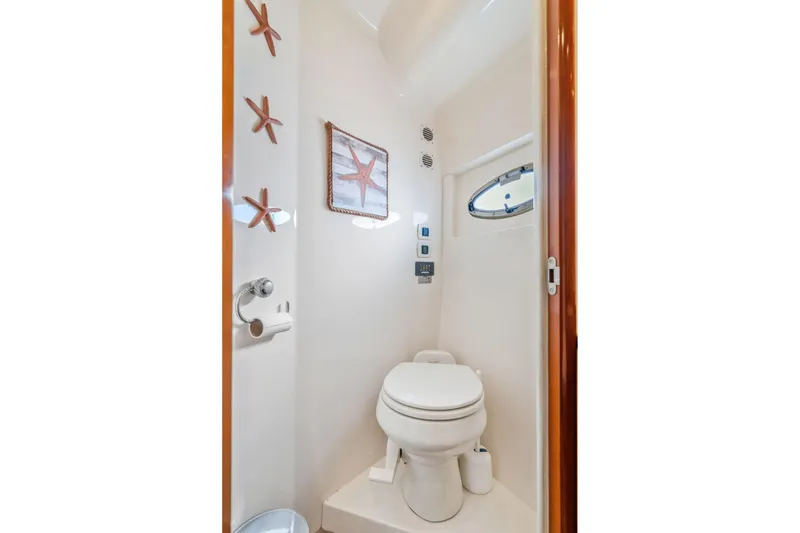 Slide: The Image of Bathroom interior of 2004 Carver 570 Voyager Pilothouse with nautical decor and porthole window. - 37