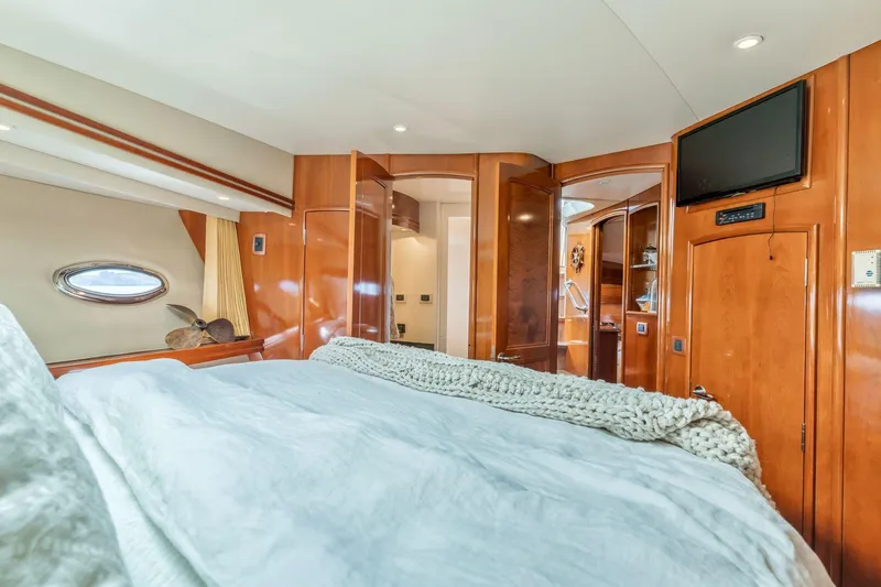 Slide: The Image of Luxurious interior of 2004 Carver 570 Voyager Pilothouse with cozy bedroom and elegant wood finishes. - 39