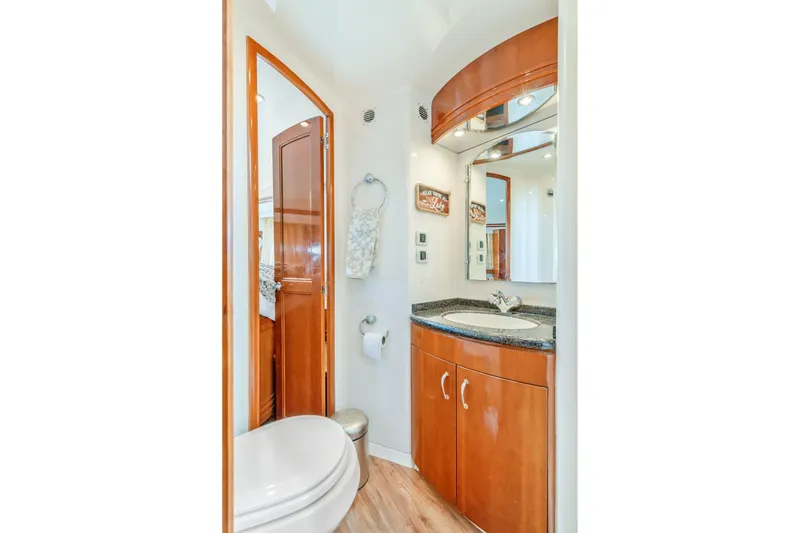 Slide: The Image of Luxurious bathroom in 2004 Carver 570 Voyager Pilothouse yacht with wood cabinetry and modern fixtures. - 41