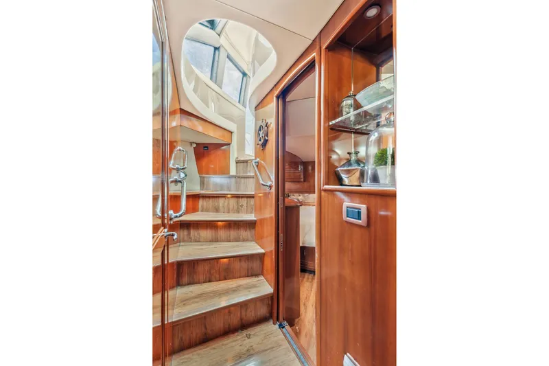 Slide: The Image of Interior staircase of 2004 Carver 570 Voyager Pilothouse with wooden finish and decorative elements. - 43