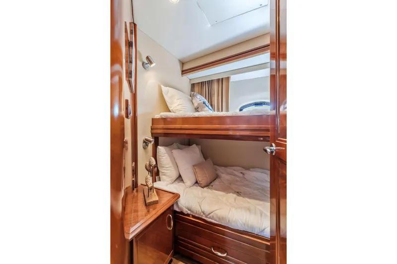 Slide: The Image of Bunk beds in 2004 Carver 570 Voyager Pilothouse with wooden interior and cozy bedding. - 44