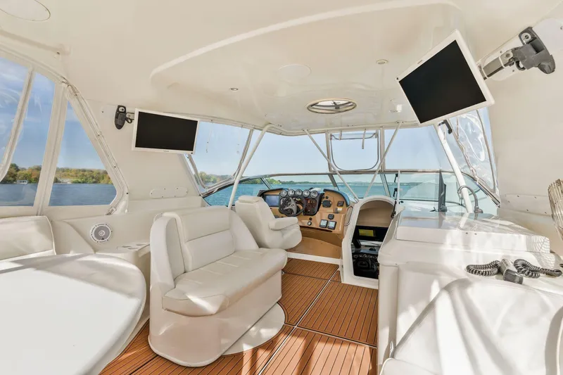 Slide: The Image of Interior of 2004 Carver 570 Voyager Pilothouse with luxurious seating and navigation equipment. - 45