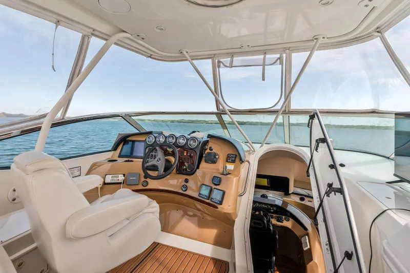 Slide: The Image of Interior view of 2004 Carver 570 Voyager Pilothouse, showcasing helm and controls. - 48