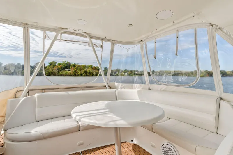Slide: The Image of Luxurious seating area on 2004 Carver 570 Voyager Pilothouse yacht with scenic water view. - 49