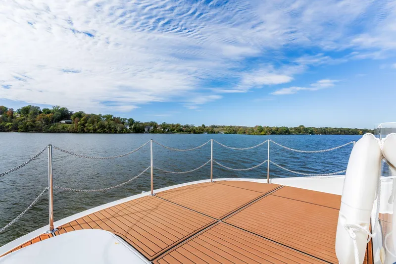Slide: The Image of Deck view from 2004 Carver 570 Voyager Pilothouse yacht on a serene lake. - 54