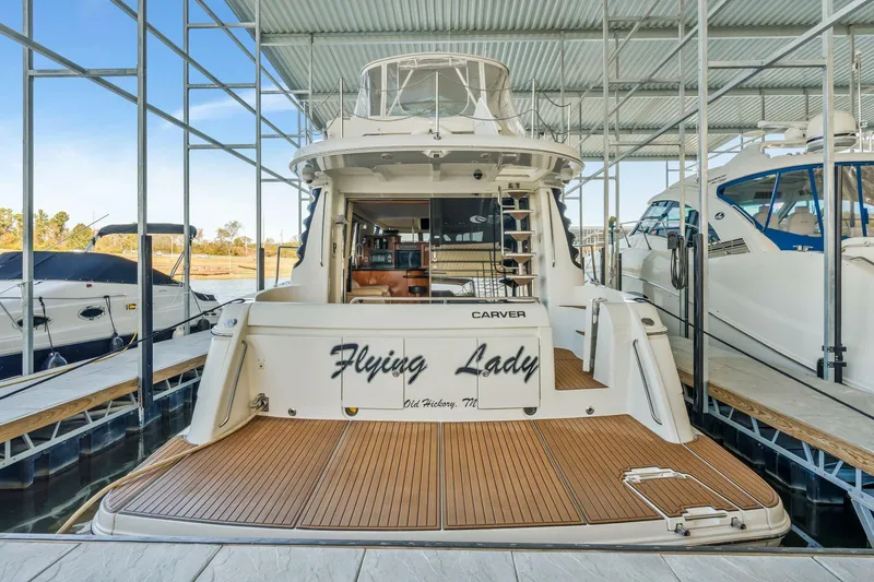 Slide: The Image of 2004 Carver 570 Voyager Pilothouse yacht docked in marina, rear view. - 60