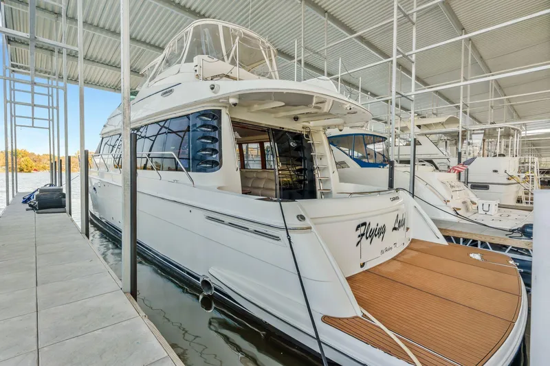 Slide: The Image of 2004 Carver 570 Voyager Pilothouse yacht docked in a covered marina. - 61
