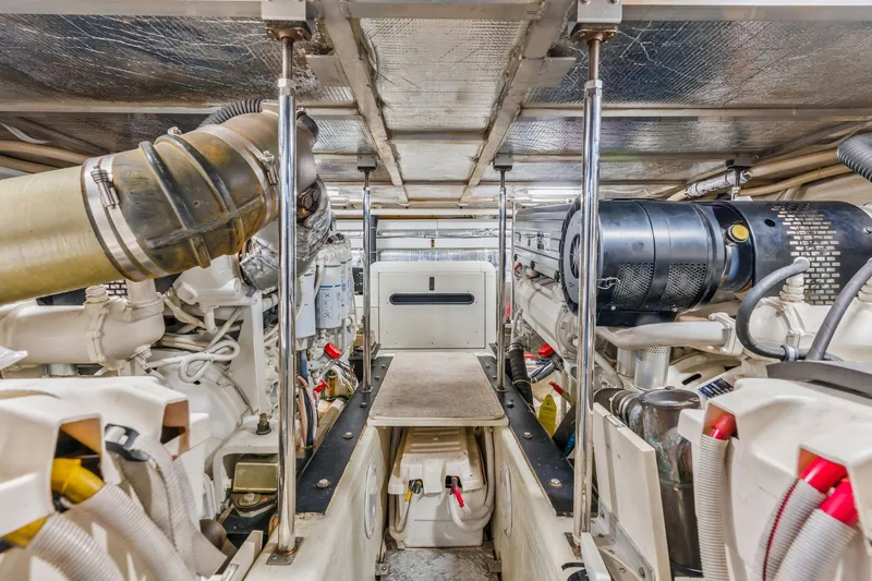 Slide: The Image of Engine room of 2004 Carver 570 Voyager Pilothouse, showcasing mechanical components and equipment. - 64
