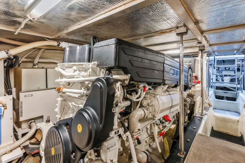 Slide: The Image of Engine room of 2004 Carver 570 Voyager Pilothouse yacht, showcasing machinery and components. - 65