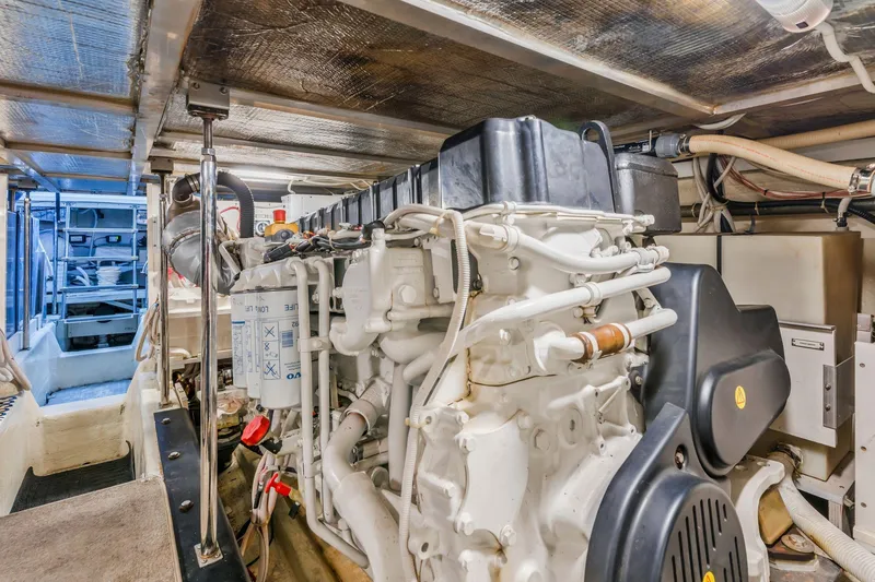Slide: The Image of Engine room of 2004 Carver 570 Voyager Pilothouse yacht, showcasing detailed machinery. - 67