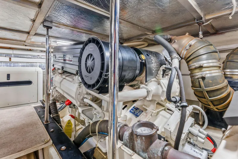 Slide: The Image of Engine room of 2004 Carver 570 Voyager Pilothouse yacht, showcasing detailed machinery. - 69