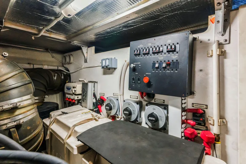 Slide: The Image of Engine room of 2004 Carver 570 Voyager Pilothouse with control panel and equipment. - 72