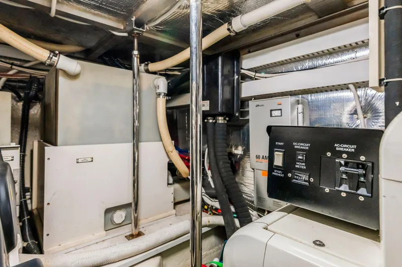 Slide: The Image of Engine room of 2004 Carver 570 Voyager Pilothouse with control panels and equipment. - 76