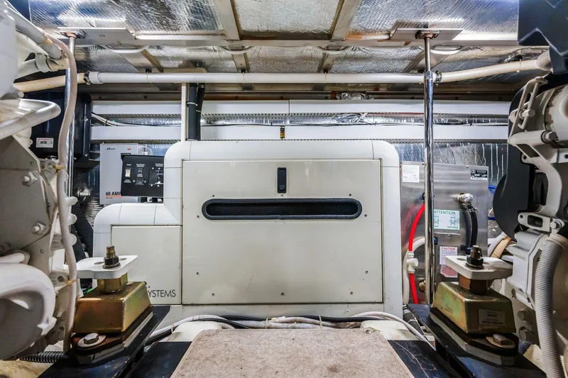 Slide: The Image of Engine room of 2004 Carver 570 Voyager Pilothouse with generator and mechanical systems. - 77