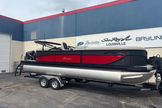 The Image of 2026 Barletta C24Q pontoon boat on trailer outside dealership. - 0