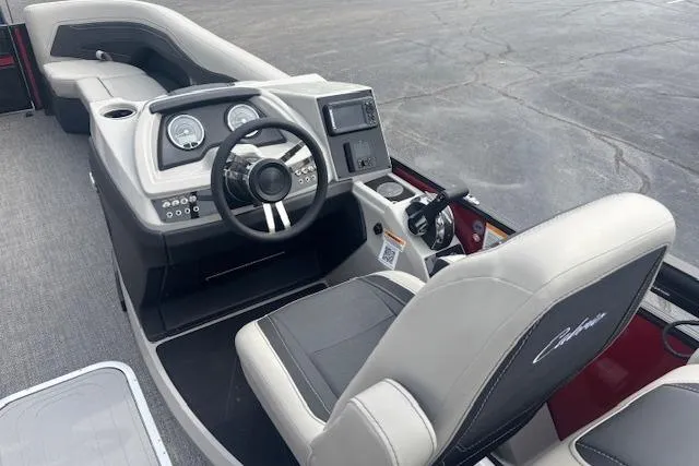 Slide: The Image of Interior view of 2026 Barletta C24Q boat, featuring modern dashboard and comfortable seating. - 7