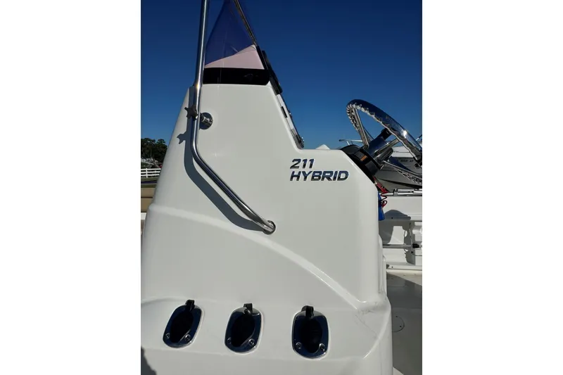 Slide: The Image of 2019 NauticStar 211 Hybrid boat console with steering wheel and controls. - 5