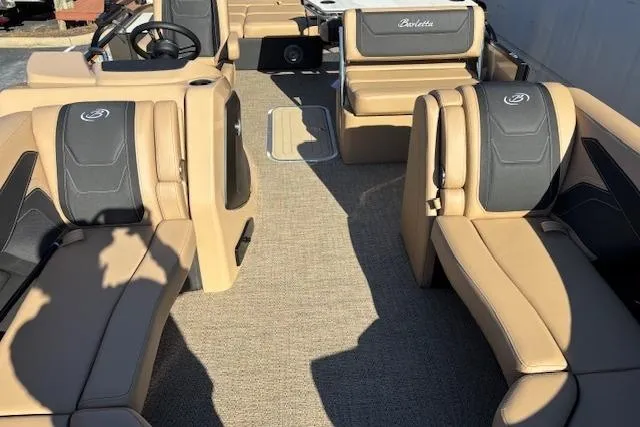 Slide: The Image of 2026 Barletta C24UE pontoon boat interior with tan and black seating. - 3
