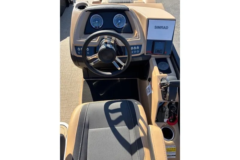 Slide: The Image of 2026 Barletta C24UE boat dashboard with steering wheel and Simrad display. - 5