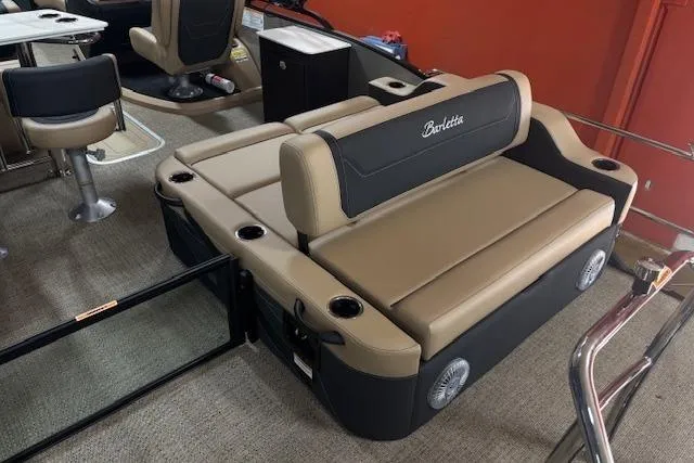 Slide: The Image of 2026 Barletta C24UE boat interior with beige seating and cup holders. - 6