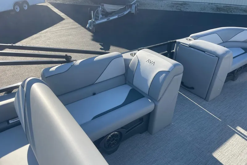 Slide: The Image of Under-seat storage compartment in 2025 Avalon Venture 2585 VRB boat, featuring sleek gray upholstery. - 19
