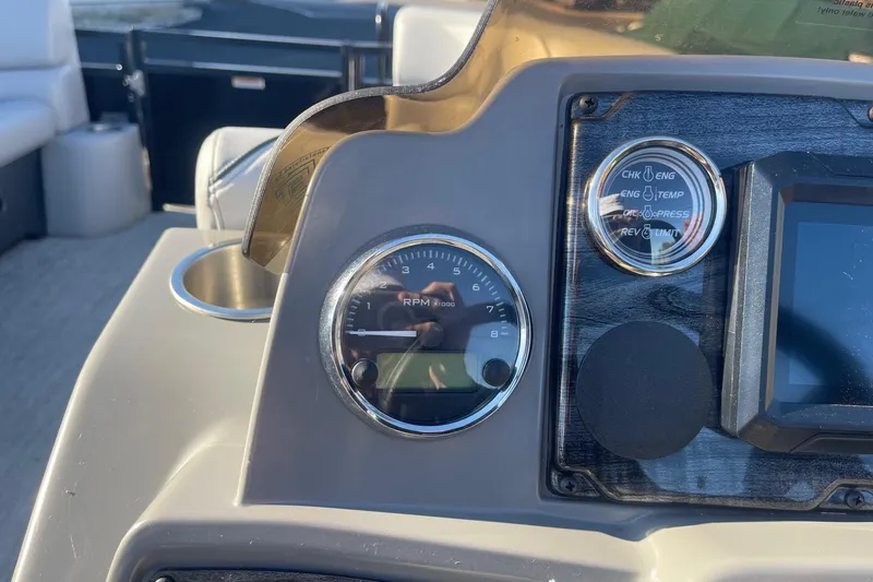 Slide: The Image of Dashboard of 2025 Avalon Venture 2585 VRB with Garmin display and fuel gauge. - 23